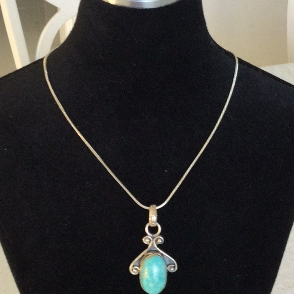 Woman’s Elegant Sliver and Turquoise Pendant chain is sliver plated.